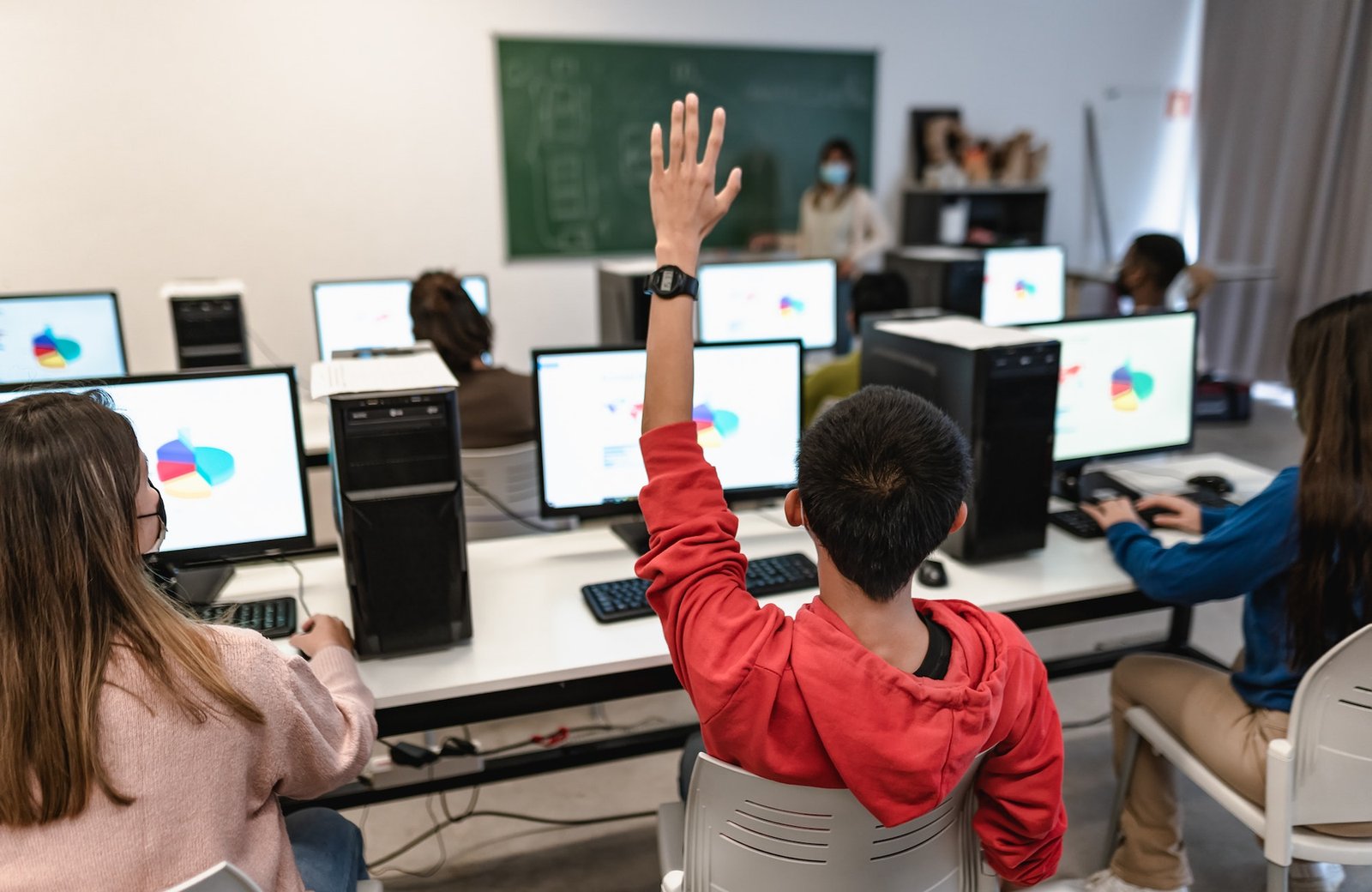 Young students listening a lesson in high school while wearing face mask during corona virus